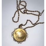 A Victorian 15 carat hallmarked gold pendant/ locket set with a ruby within a star, having scroll