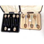 A hallmarked silver and coloured enamel set of coffee spoons,, Birmingham 1931, cased; a set of