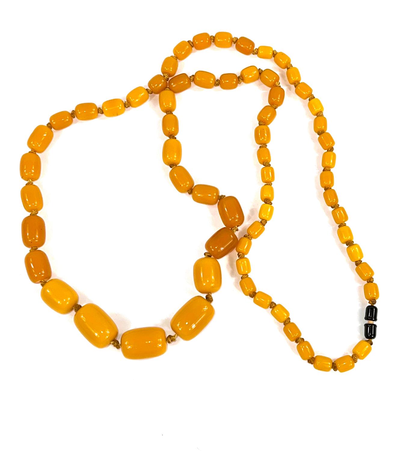 A string of graduated butterscotch beads, 1 - 3cm, 118cm length