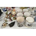 A Royal Worcester figure of a boy; a Royal Worcester bird; a selection of mugs