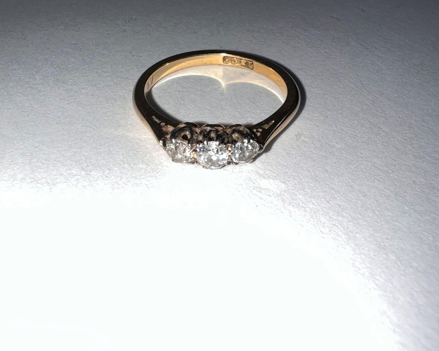 A yellow metal dress ring stamped ‘18ct’ set 3 small diamonds (central stone approximately •1 - Image 2 of 2