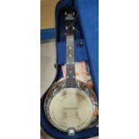 A George Formby ukulele banjo in bird's eye maple and chrome, in a case with booklet and music