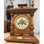 An Edwardian mantel clock with striking movement in architectural walnut case