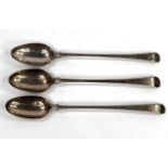 Three silver basting spoons, Old English bottom marked, 2 decorated with fists and wreaths, 1 with a