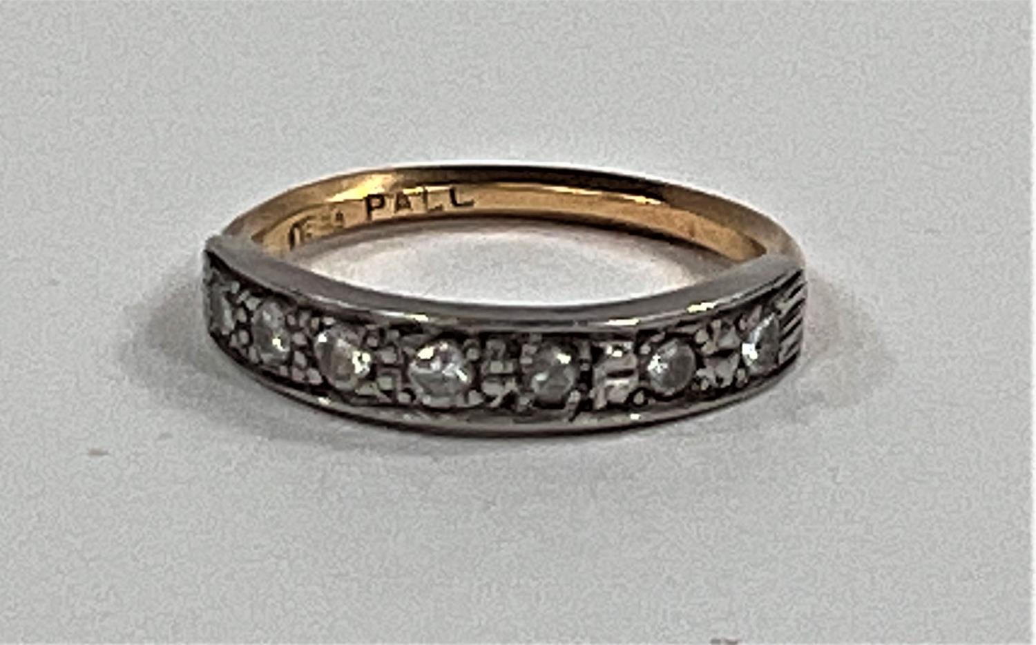 A half eternity ring set with 7 small diamonds on yellow metal shank, stamped 18ct, size K, 2.4gms