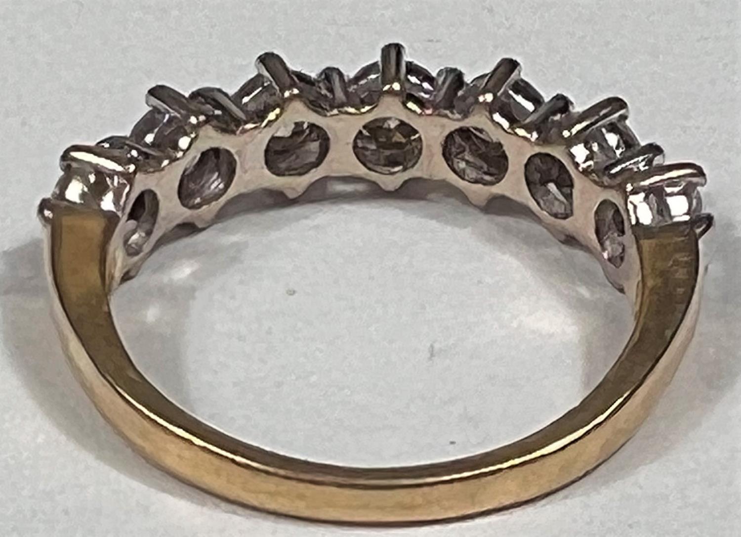 An 18 carat hallmarked gold half eternity ring set 7 diamonds, 3.5mm diameter of stones approx - Image 6 of 7