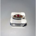 An 18 carat hallmarked gold gypsy style dress ring set 3 rubies and 2 old cut diamonds in split