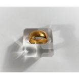 A small wide barrel shaped 22 carat hallmarked gold wedding ring, 6gm