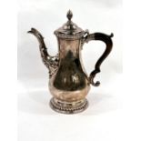A Georgian hallmarked silver baluster coffee pot with gadrooned rim and circular foot, acanthus