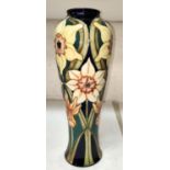 A Moorcroft vase  of inverted baluster form decorated with narcissi against a dark blue ground,