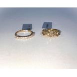 2 9 carat hallmarked gold rings, 1 set with 3 flowerheads of champagne diamonds, 23 in all, 1