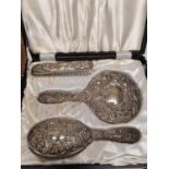 A cased three piece silver brush and mirror set