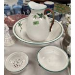 A Victorian ceramic bathroom set with jug, bowl, soap dish etc, with leaf and branches in relief