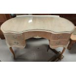 A modern Olympia kidney shaped dressing table with drawers bellow