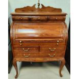 A carved wooden rolltop bureau with fitted interior, brass inlay various drawers etc depth 91cm