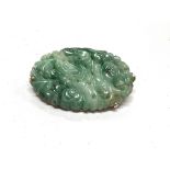 A Chinese Jade mottled oval pierced brooch with yellow metal surround, stamped 14K