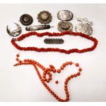 A selection of silver/white metal brooches, coral necklaces, etc.