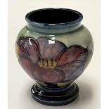 A Moorcroft squat vase with foot, blue ground Clematis