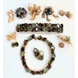 A mid 20th century selection of gilt metal costume jewellery:  Dior; Trifari; Kramer; Boucher; etc.