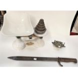 A WWI bayonet; a vintage AA badge; a set of white enamel kitchen scales