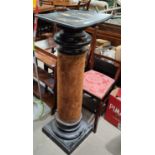 A ebonised wooden pillar stand with turned detailed, squared base, felt column. (some loss and