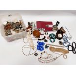 A selection of costume jewellery including brooches, necklaces etc.