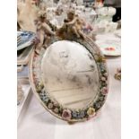 A 19th century Dresden mirror with 2 cherubs above, with floral encrusted decoration, height 33cm (
