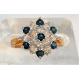 A yellow metal ring set large blue stone, stamped '14k', 3.9gm; a cluster ring set blue/clear stones