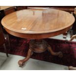 An oval tilt top mahogany supper table with base, 121cm.