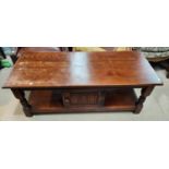 An oak coffee table with cupboard and under shelf below