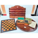 An oval inlaid mahogany tray; a mahogany letter rack, a chess and draughts set