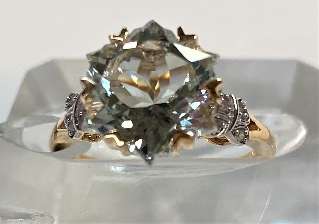 A lady's 9 carat gold dress ring set Wobito snowflake cut prasiolite stone, 4.12 carat, flanked by 4