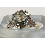 A lady's 9 carat gold dress ring set Wobito snowflake cut prasiolite stone, 4.12 carat, flanked by 4