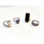 Four white metal rings st. 925, one with clear tanzanite style stone, one set with pearl, one with