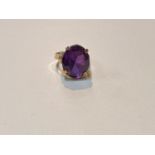 A yellow metal ring with large amethyst stone, Egyptian marked, weight 5.9gms, size M.