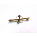 An Edwardian yellow metal bar brooch with seed pearl and ruby flower, stamped 9ct. 2 gm