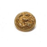 A Chinese yellow metal brooch with detailed relief decoration of a carp, fish etc., circular form,