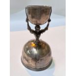 A Continental silver wage bridal cup, with bridal figure holding bowl over head, ht. 13cm, 4.6oz