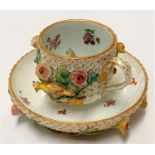 A Meissen Snowball (Scheeballen) cup and saucer, heavily encrusted with flowers and birds, sword