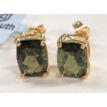 Two pairs of '9K' gold earrings set rectangular green colour change andesines; another '9K' pair set