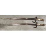 Two 19th century brass handled sword bayonets with stamped numbers