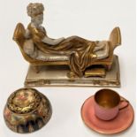 A miniature Wedgewood cup and saucer in pink & gilt; a Sitendorf figurine: Madame Recamier, in