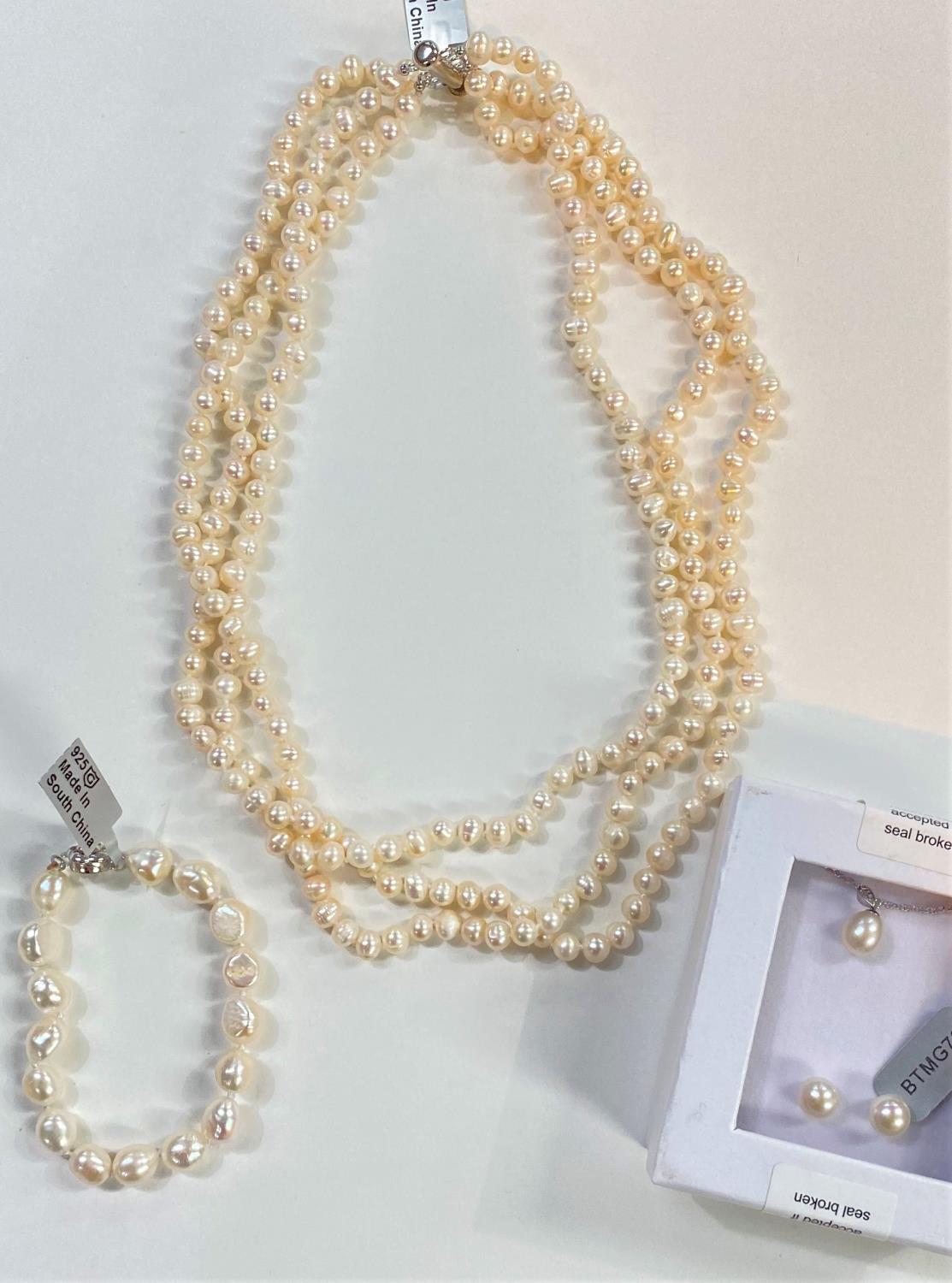 A triple necklace of naturally coloured kaori pearls, 6.5 x 5mm; a similar pearl pendant necklace