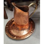 A copper and brass handled jug; a copper charger