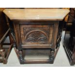 A reproduction "Credence" cupboard/hall table in carved and canted oak