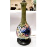 A Moorcroft table lamp with green ground floral decoration, full height 42cm
