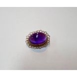A 9ct gold brooch with large amethyst oval cabochon stone with lace border, gross weight 4.6gms.
