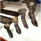 A set of graduating ladies boots, vases/measures  ht. largest 23cm, smallest 11cm