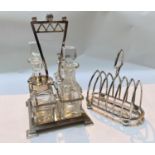 An Art Deco squared glass and silver plated oil/salad cruet stand with stepped base and a silver