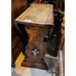 An oak occasional table with swivel drop leaf top